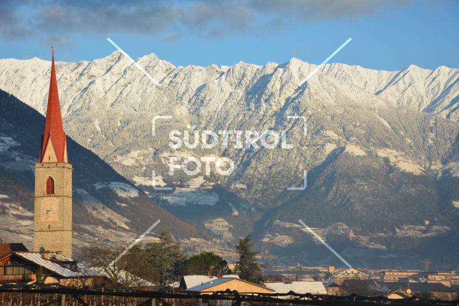 Kirchturm mit Berge im Hintergrund